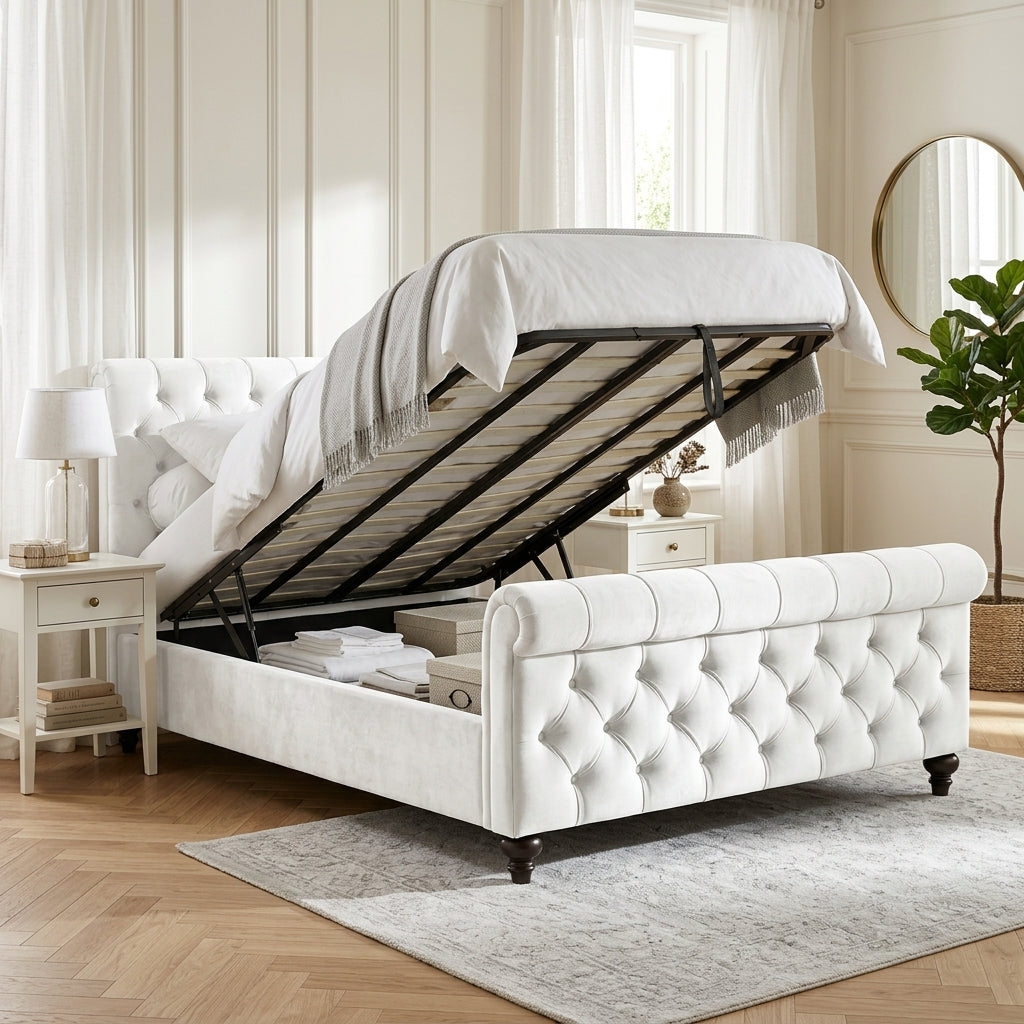 A white tufted storage bed with a lift-up gas-activated headboard, shown in a bright, modern bedroom setting with a gray rug, wooden floor, and bedside tables.