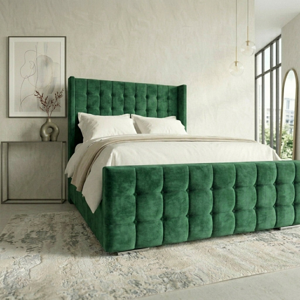 A green tufted velvet bed frame with wingback-style backrest and headboard, styled with white bedding in a modern bedroom setting.
